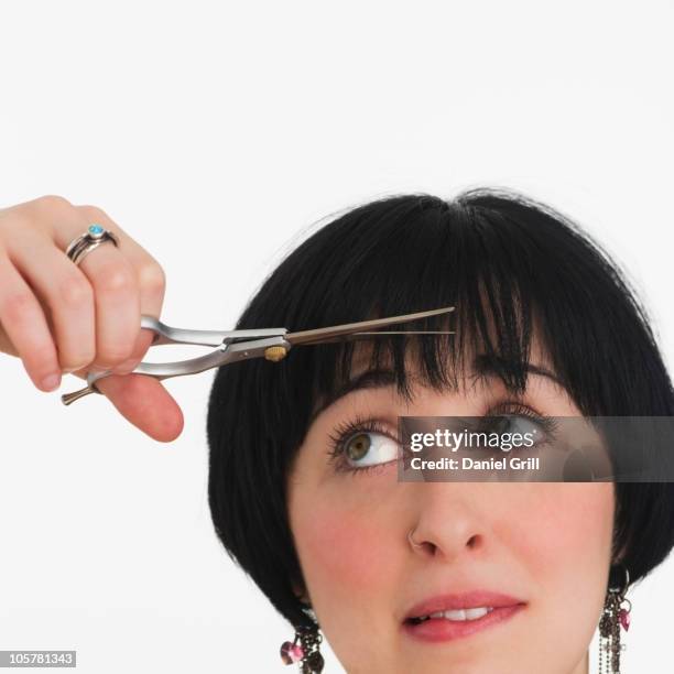 nervous woman watching her hair being cut - fringe stock pictures, royalty-free photos & images