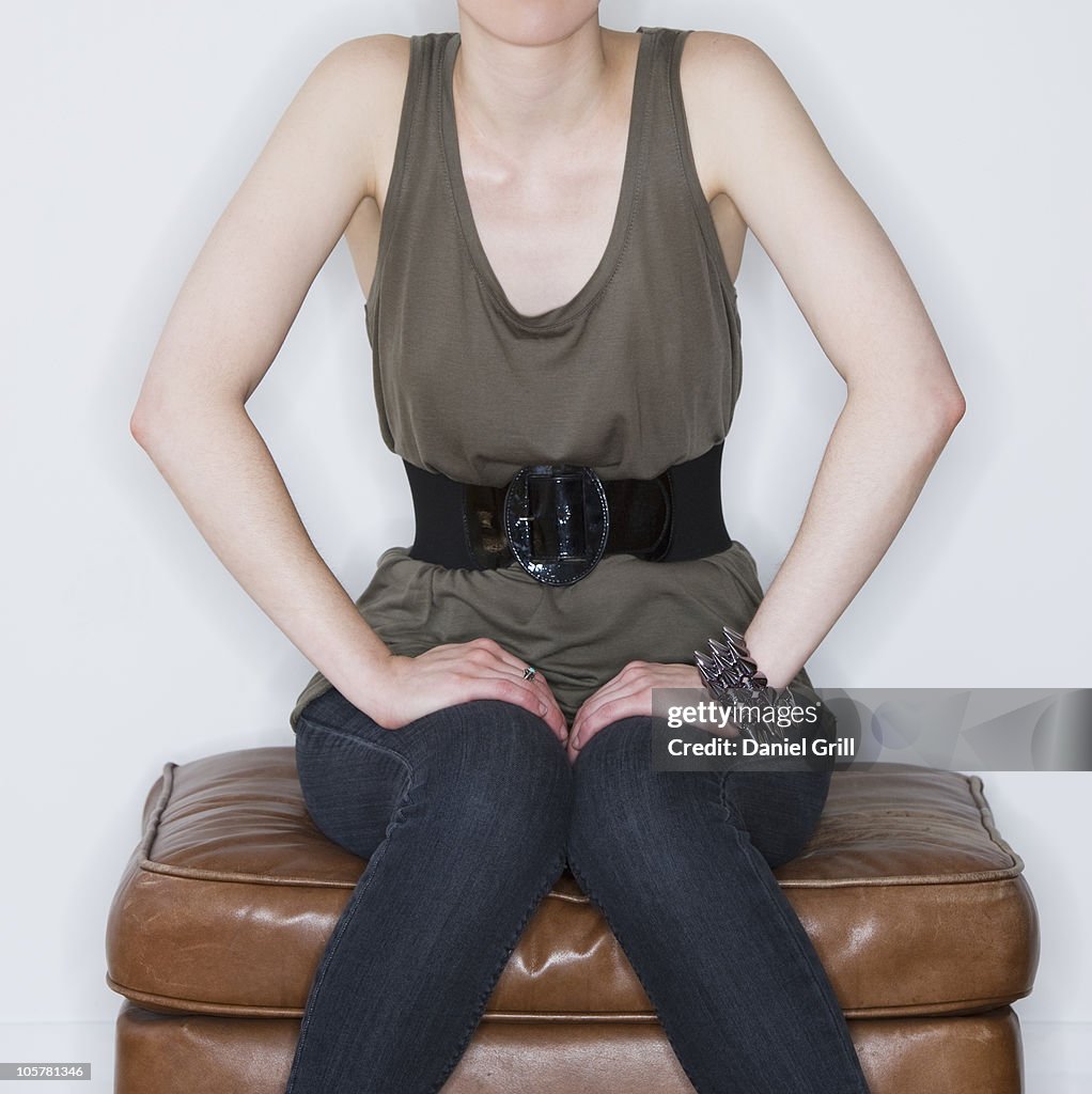 Woman sitting on ottoman