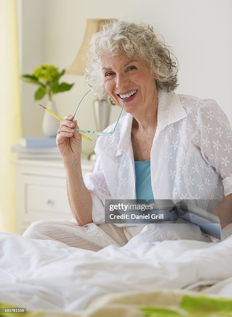 Woman reading a book in bedroom