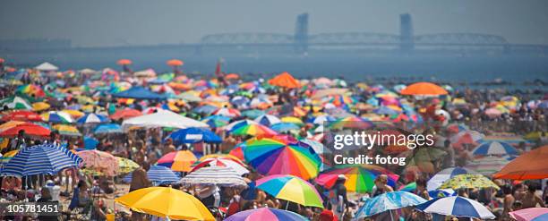 sun umbrellas at the beach - coney island stock pictures, royalty-free photos & images