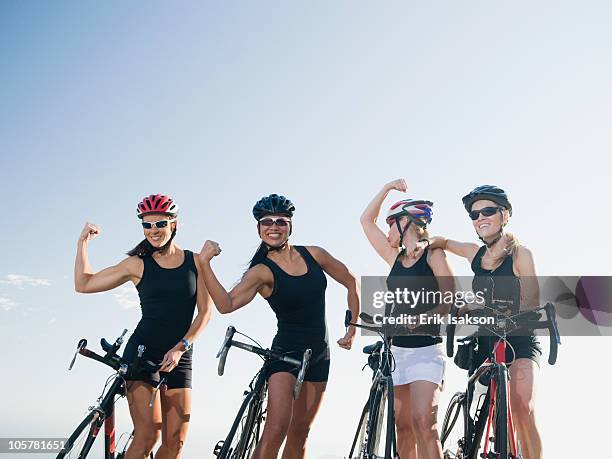 cyclists flexing their biceps - group of people flexing biceps stock pictures, royalty-free photos & images