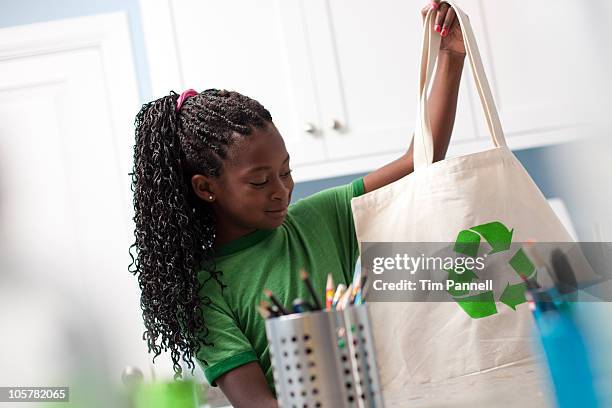 young girl holding reusable shopping bag - cloth bag stock pictures, royalty-free photos & images