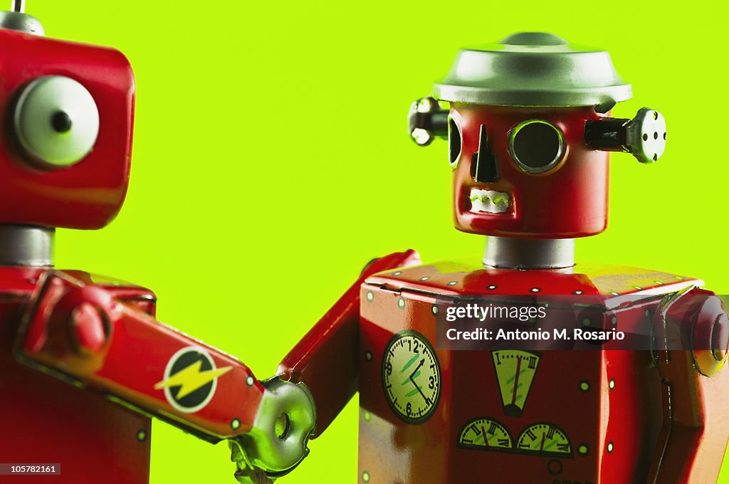 Toy robots shaking hands