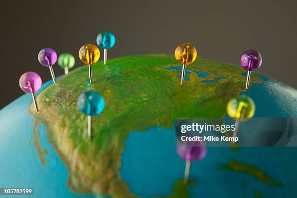 push pins on globe - desktop globe stock pictures, royalty-free photos & images