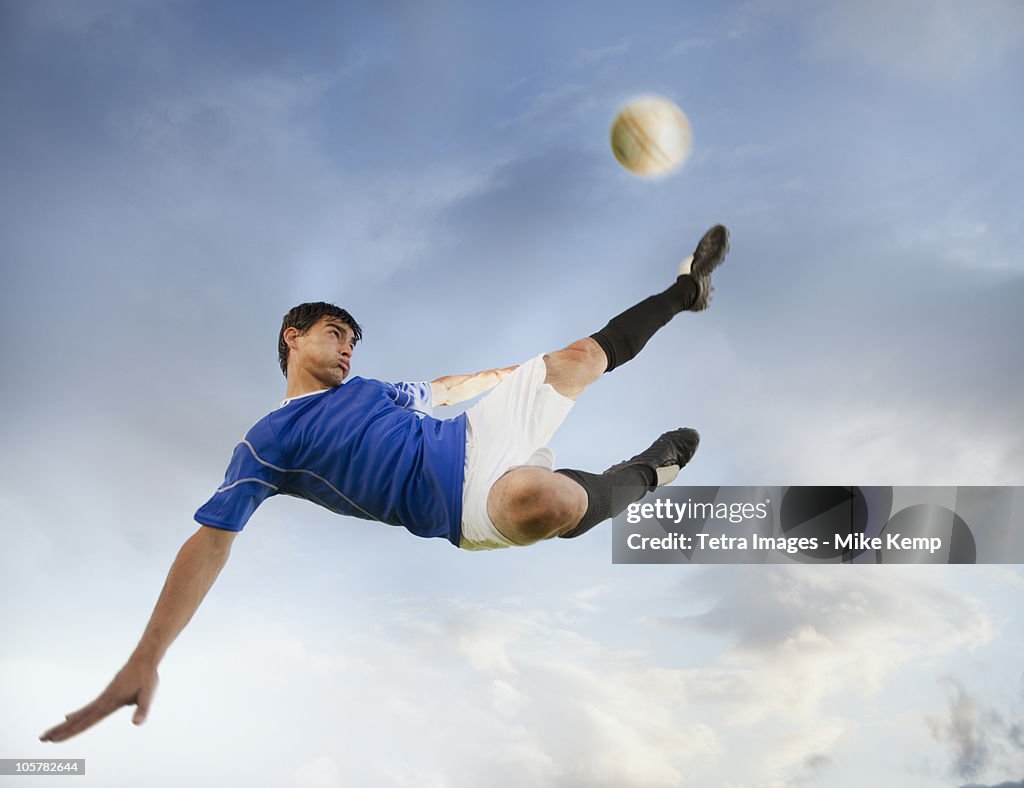 Soccer player kicking ball