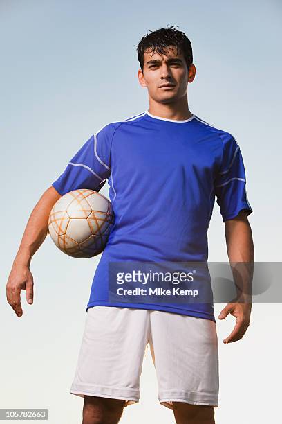 soccer player holding ball - man playing ball fotografías e imágenes de stock