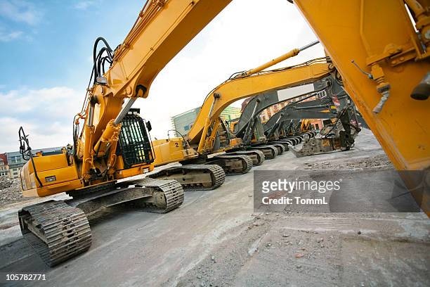 bulldozers in a row - construction equipment stock pictures, royalty-free photos & images