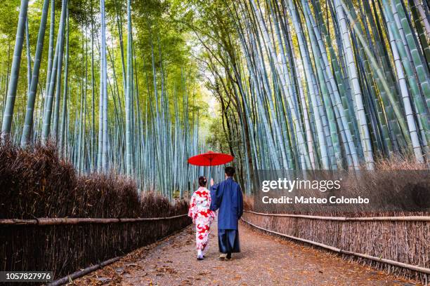 japanese couple in kimono at bamboo forest, kyoto, japan - japan culture stock pictures, royalty-free photos & images