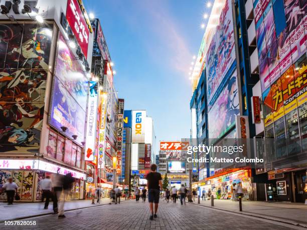 teenager walking, akihabara electric town, tokyo, japan - 商業地域 ストックフォトと画像