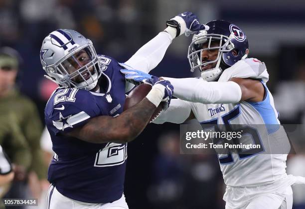 Ezekiel Elliott of the Dallas Cowboys tries to hold off Logan Ryan of the Tennessee Titans on a run in the first quarter of a game at AT&T Stadium on...