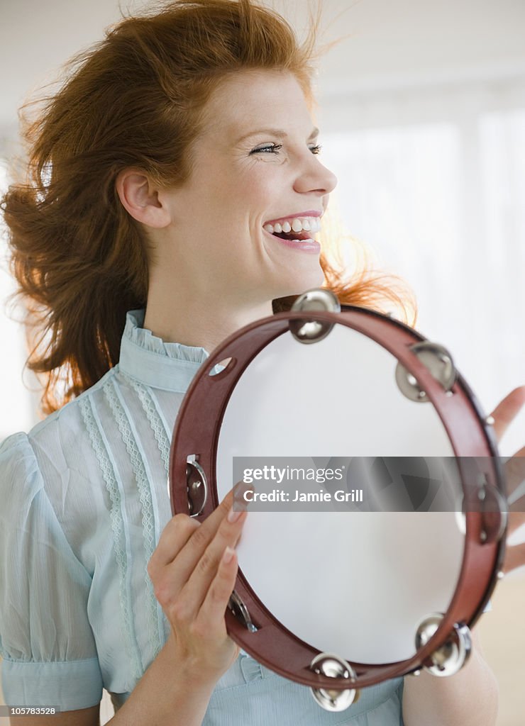 Woman playing tambourine