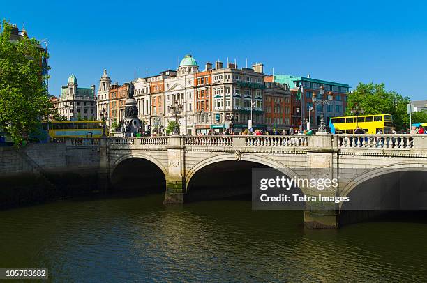 o'connell bridge over river liffey - dublin bus stock pictures, royalty-free photos & images