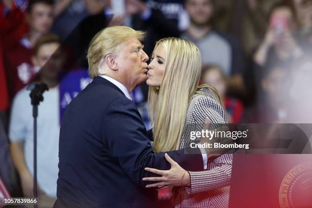 President Donald Trump, left, kisses Ivanka Trump, assistant to President Trump, during a rally with U.S. President Donald Trump in Fort Wayne,...