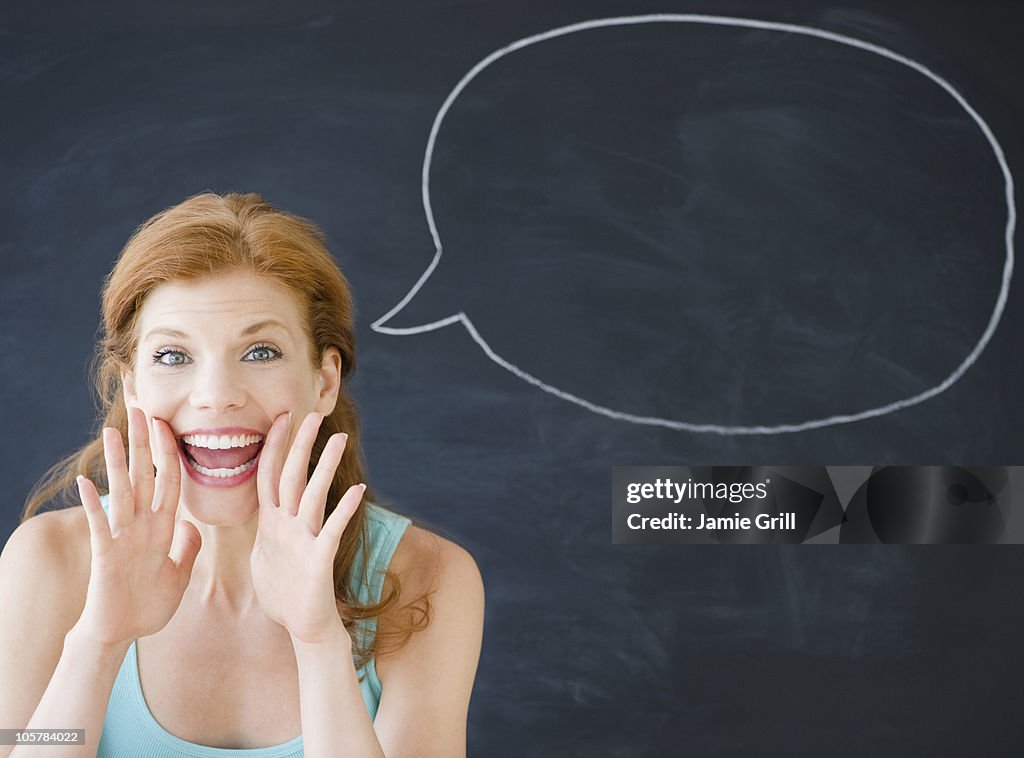 Woman standing in front of a speech bubble