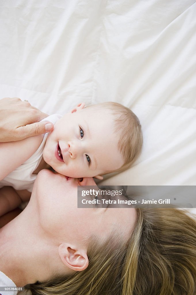 Mother and baby lying down together