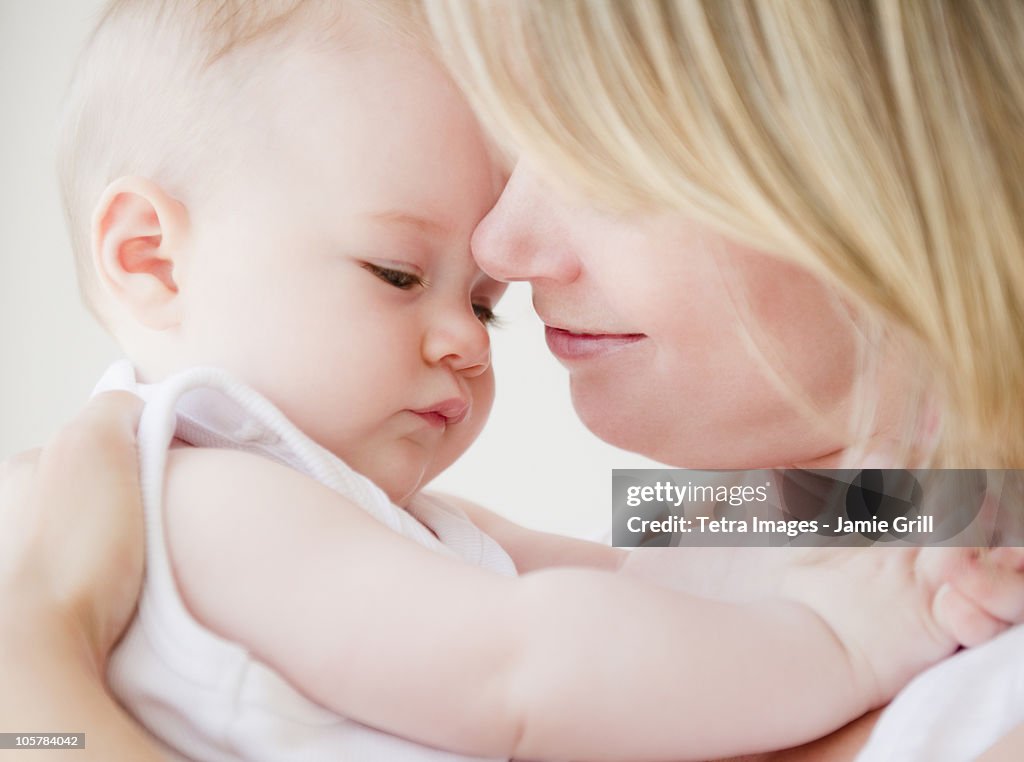 Mother embracing her baby daughter