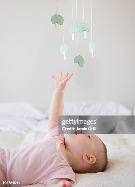 baby playing with mobile - baby mobile stock pictures, royalty-free photos & images