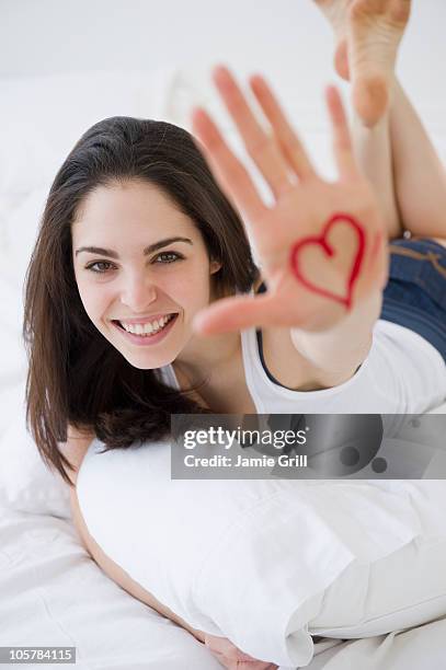 woman with a heart drawn on her hand - lipstick heart stock pictures, royalty-free photos & images