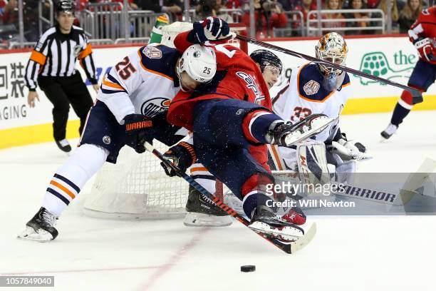 Darnell Nurse of the Edmonton Oilers checks Dmitrij Jaskin of the Washington Capitals during the second period at Capital One Arena on November 5,...