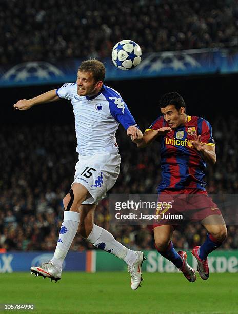 Pedro Rodriguez of Barcelona duels for a high ball with Mikael Antonsson of FC Copenhagen during the UEFA Champions League group D match between...