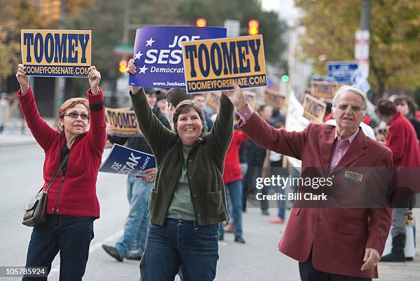 Pat Toomey and Joe Sestak supporters wave signs at passing cars before the start of the Pennsylvania Senate debate between the two candidates in...