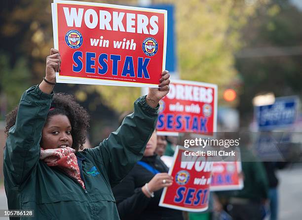 Pat Toomey and Joe Sestak supporters wave signs at passing cars before the start of the Pennsylvania Senate debate between the two candidates in...