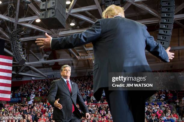 President Donald Trump greets talk show host Sean Hannity at a Make America Great Again rally in Cape Girardeau, Missouri on November 5, 2018.
