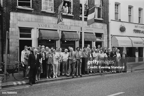 Customers gathering around the York Minster, now known as The French House, pub at 49 Dean Street, Soho, London, UK, 19th July 1979.