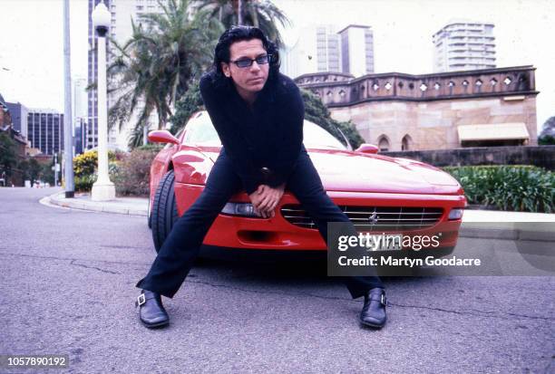 Michael Hutchence , singer with INXS, poses for portraits with a Ferrari in Sydney , Australia, 1996.