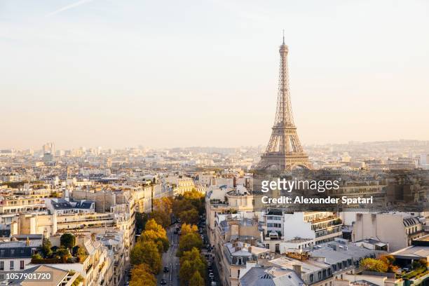 elevated view of eiffel tower and paris skyline at sunset, france - paris france stock-fotos und bilder
