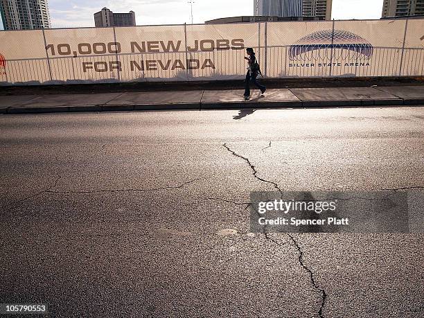 Woman walks by a halted construction project on Las Vegas Boulevard on October 20, 2010 in Las Vegas, Nevada. Nevada once had among the lowest...