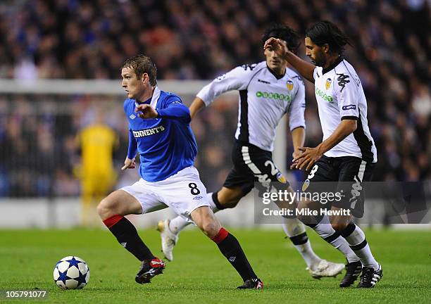 Steven Davis of Rangers gets past Alejandro Dominguez of Valencia during the UEFA Champions League Group C match between Glasgow Rangers FC and...