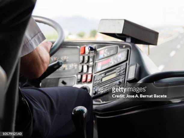 hands of a driver of bus to the steering wheel driving for a road of several rails, highway  a 7 - e 15, spain, europe. - bus imagens e fotografias de stock