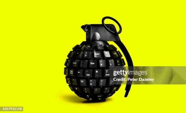 cyber attack grenade on yellow background - threats ストックフォトと画像