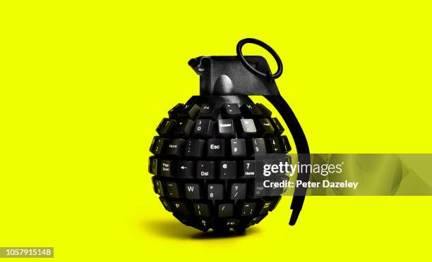 cyber attack grenade on yellow background - criminal investigation - fotografias e filmes do acervo