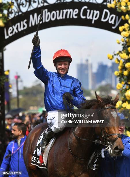 Jockey Kerrin McEvoy waves to the crowd as he returns to the mounting yard after winning the Melbourne Cup on British horse Cross Counter in...