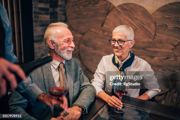 joyful old couple drinking wine - drunk husband stock pictures, royalty-free photos & images