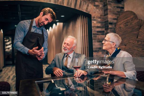 older couple ordering wine - sommelier stock pictures, royalty-free photos & images