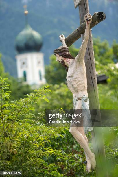 a churchyard crucifix in oberammergau, germany. - oberammergau stock pictures, royalty-free photos & images