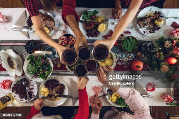 family dining at christmas table - table wine food stock pictures, royalty-free photos & images