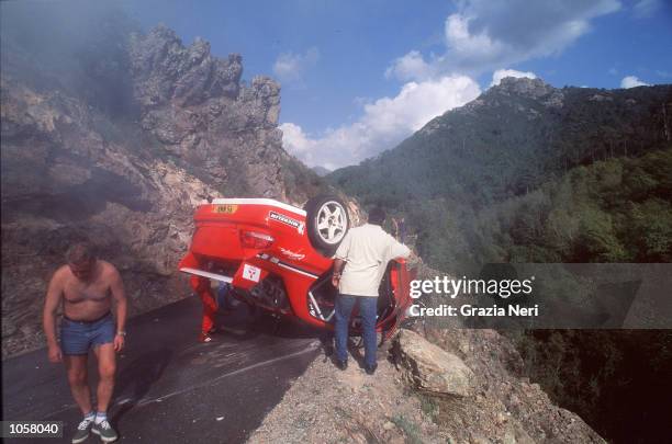 Tommi Makinen's car lies on the edge of the road follwoing a crash during the Rally of Corsica, a part of the World Rally Championship. DIGITAL IMAGE...