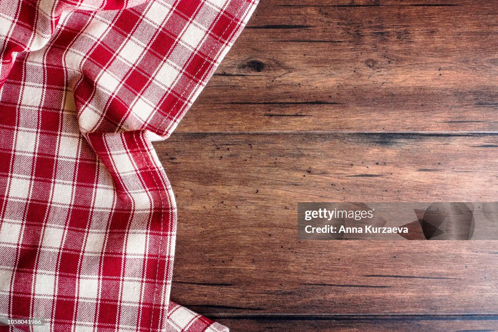 Textile background with a checkered red napkin, top view. Natural textile background. Fabric texture background. Texture of natural linen fabric.