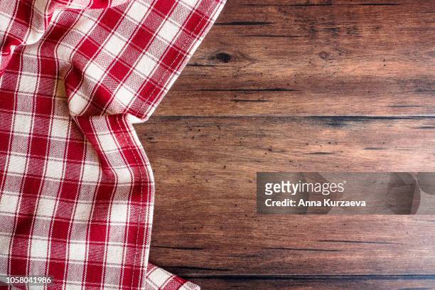 textile background with a checkered red napkin, top view. natural textile background. fabric texture background. texture of natural linen fabric. - schottenkaro stock-fotos und bilder