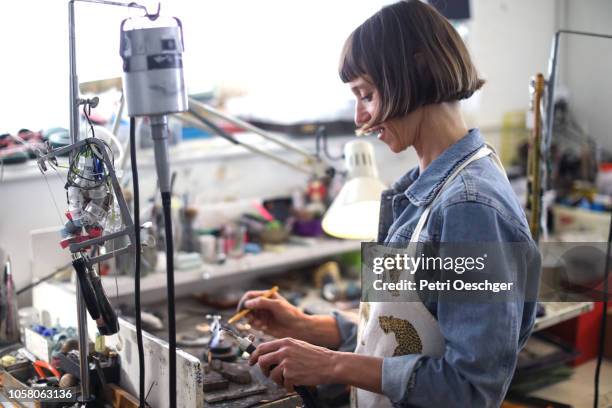 a jewellery designer working in her studio. - jewellery designer stock pictures, royalty-free photos & images