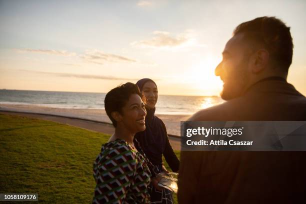 group of friends having barbecue at beach at sunset - perth australia fotografías e imágenes de stock