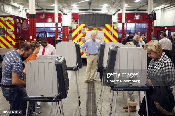 Voters cast ballots at a polling station in Carmel, Indiana, U.S., on Tuesday, Nov. 6, 2018. Today's midterm elections will determine whether...