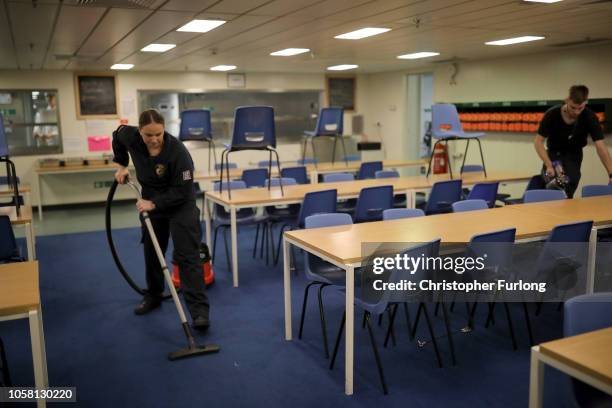 Sailor cleans the mess area HMS Queen Elizabeth as it sails towards New York on October 19, 2018 in New York City. HMS Queen Elizabeth, Britain's...