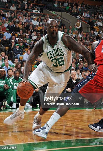 Shaquille O'Neal of the Boston Celtics makes a move to the basket against Johan Petro of the New Jersey Nets on October 20, 2010 at the TD Garden in...