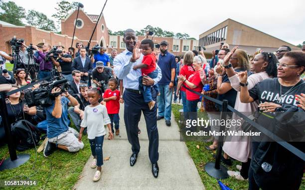 Tallahassee mayor and Florida Democratic gubernatorial candidate Andrew Gillum waves at supporters after casting his ballot with his children, four...