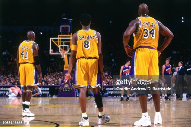 Kobe Bryant and Shaquille O'Neal of the Los Angeles Lakers stand during a game circa 1999 at the Great Western Forum in Inglewood, California NOTE TO...